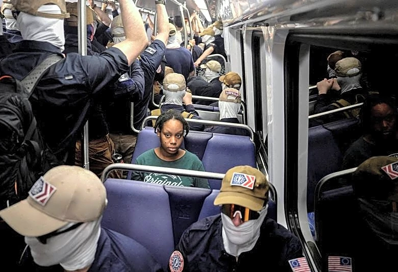 PICTURE AND ITS STORY-Patriot Front members and a solitary woman travel on a DC train