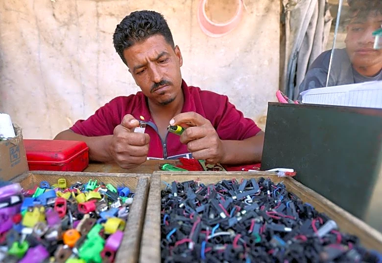In Gaza's tent camps, a cigarette lighter becomes a lifeline