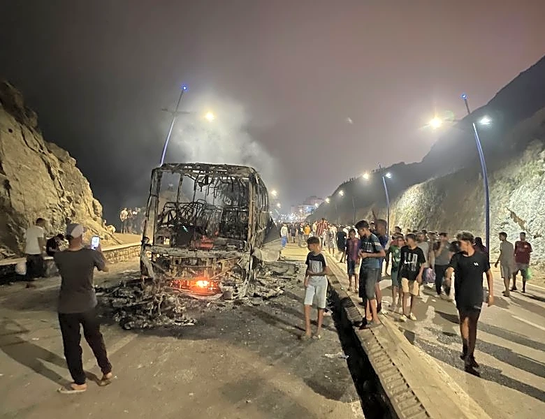 Sleepless night near border of Spain's Ceuta as migrants torch vehicles