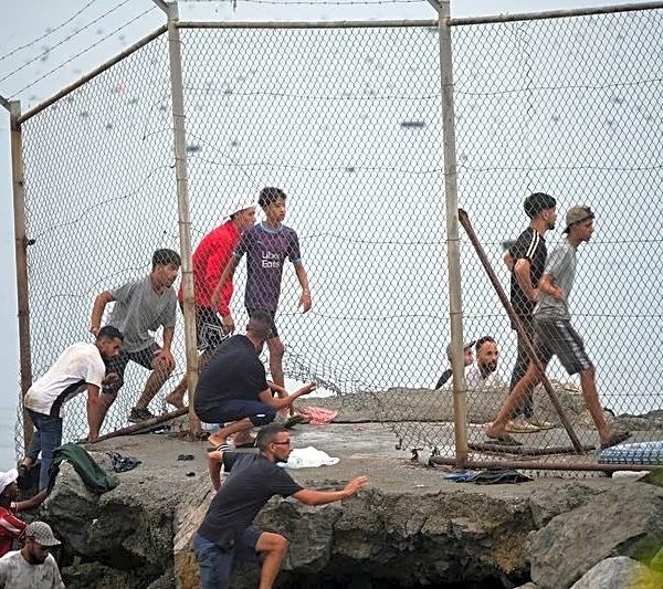 Spain says huge surge across border into enclave has reversed, half of migrants go back