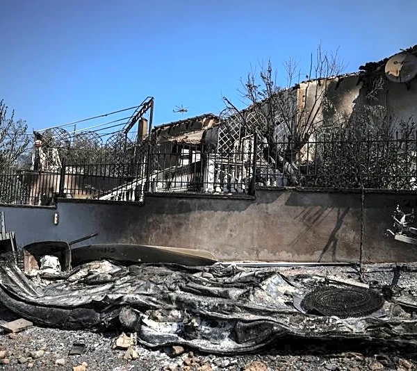Wildfires ease in Greece as people return to gutted homes