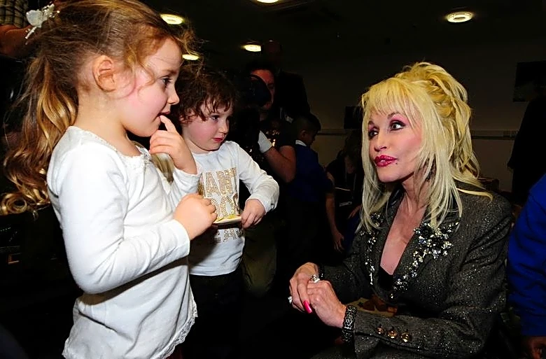 Dolly Parton's legacy lives on through book deliveries to kids