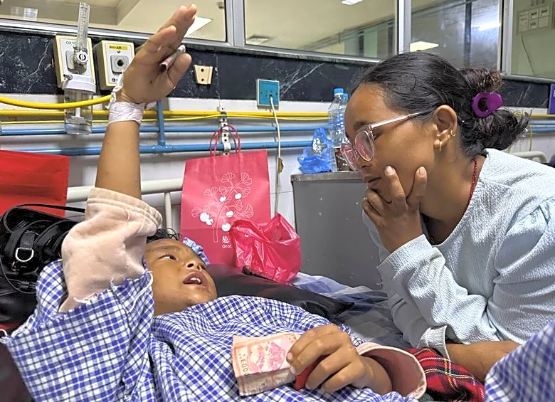 Mother reunited with 8-year-old who climbed trees to survive Nepal floods