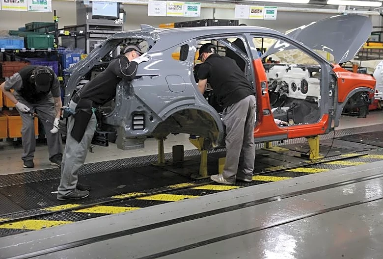 UK manufacturing PMI slips to five-month low but hiring strengthens
