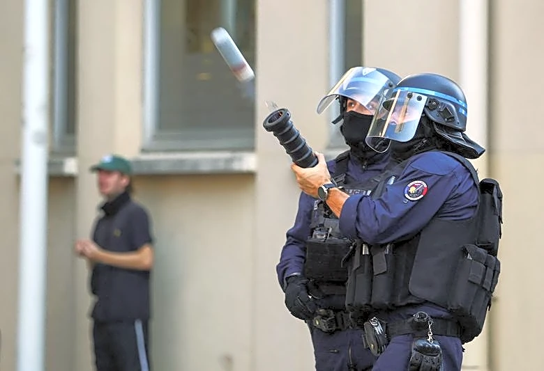 France suspends use of stun grenades to police student protests