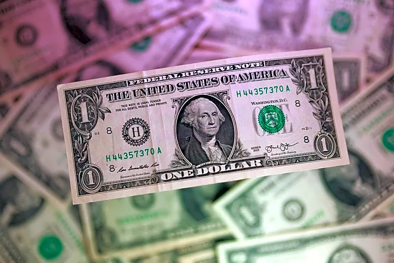Dollar hits 18-month high, then cools as investors await patient Fed
