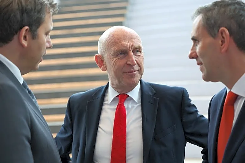 Asked on bank tax, UK's Healey stresses sector's broader contribution