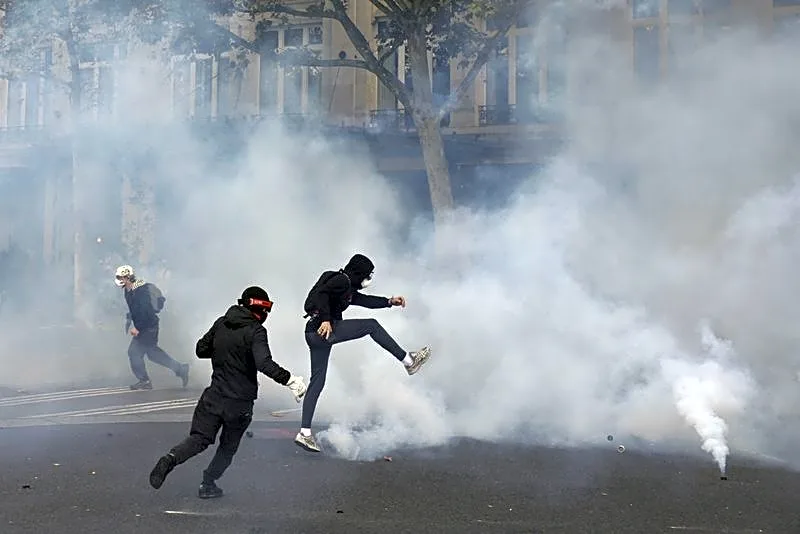French police clash with protesters as tens of thousands rally over cost of living