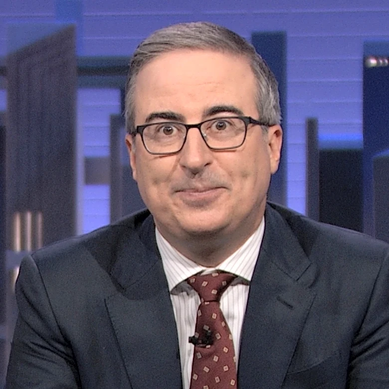 John Oliver Greets His New Skydance Overlords With Sexy Fanfic Pics of Insurance Mascot