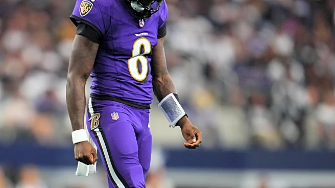 Lamar Jackson exits practice with S&C Coach Elliott and Chief Medical Officer