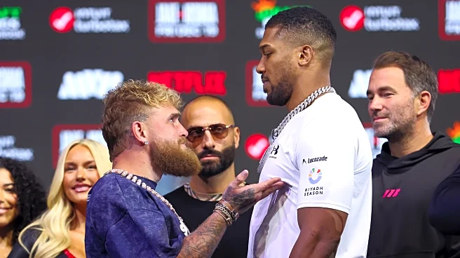 Anthony Joshua towers over Jake Paul in first faceoff during fight week
