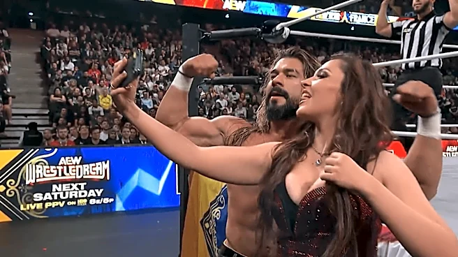 Andrade receives a kiss from his next title challenger