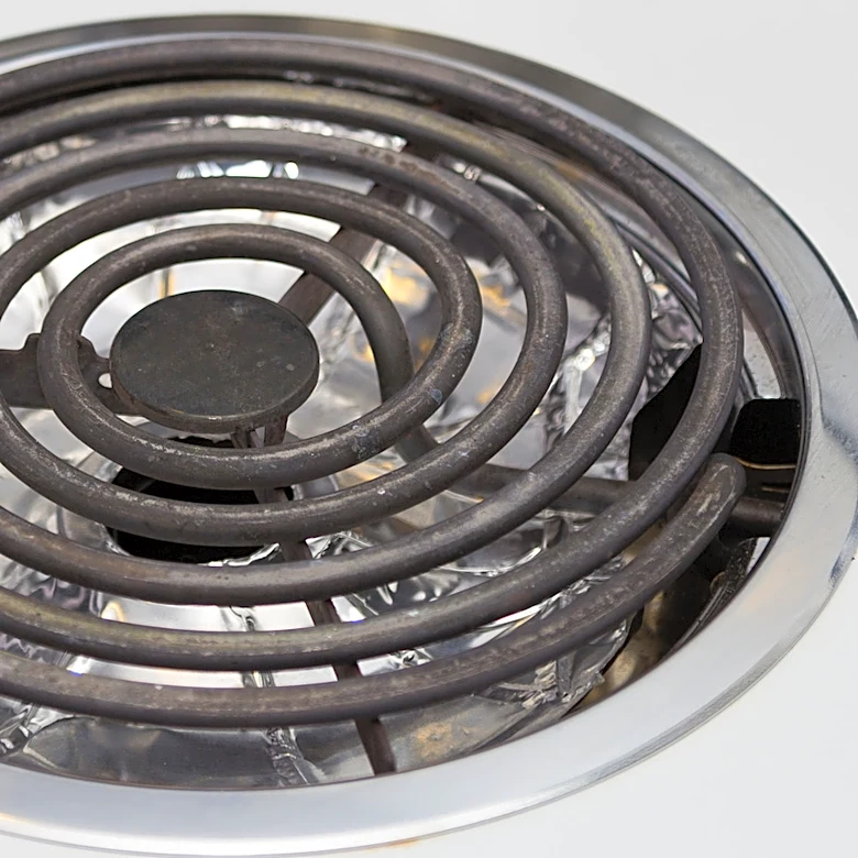 The Dangerous Reason You Should Stop Using Aluminum Foil To Keep Your Electric Stove Clean