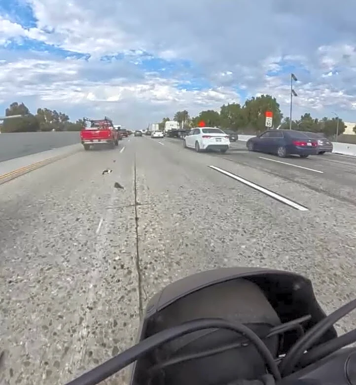 Motorcyclist Runs Into Highway Traffic When He Realizes ‘Trash’ In Road Is Breathing