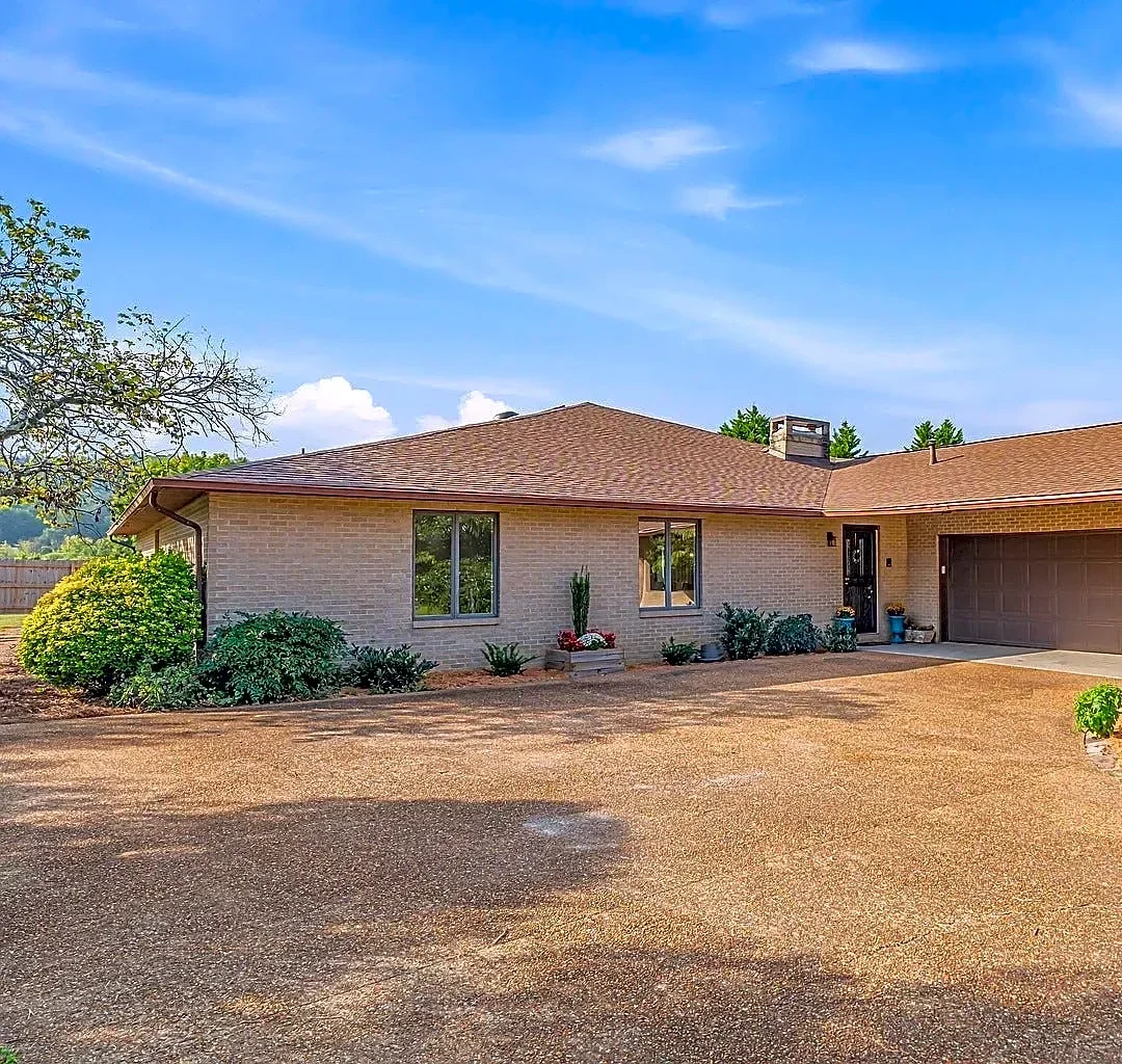 This house for sale in Halls is brick ranch in front, pool party inside