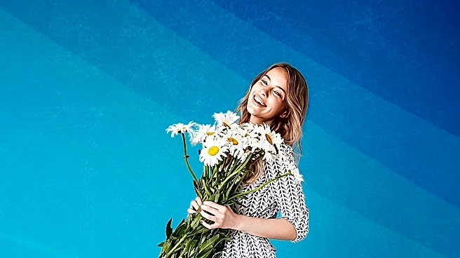 Natalia Dyer Showcases Manolo Blahnik's Leva Sandals, Boosting Winter White Trend