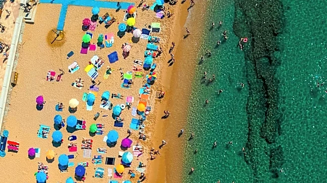 Hampton Beach Tourists Adapt to Rainy Weather with Umbrellas