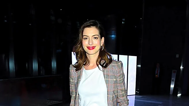 Anne Hathaway Showcases Pregnancy in Denim Look at Film Premiere