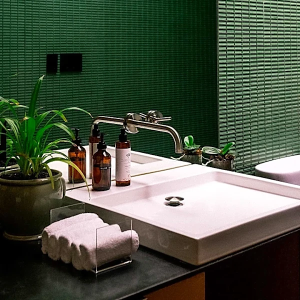 Bathroom Undergoes Dramatic Transformation from Beige to Dark Green Tile