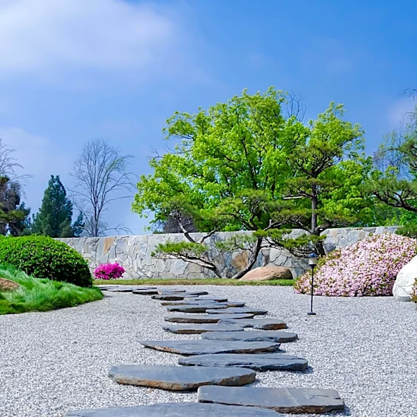Garden Design Emphasizes Gravel and Stepping Stones Over Paved Paths for Softer Aesthetic