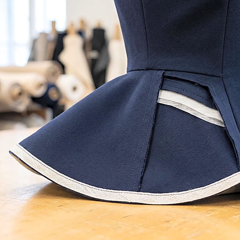 The Hidden Support Inside a Peplum That Holds Its Line