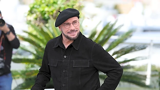 John Travolta's 'old-school director' ensemble at Cannes goes viral