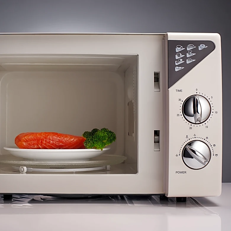 Detective charged with pulling gun on fellow officer microwaving fish