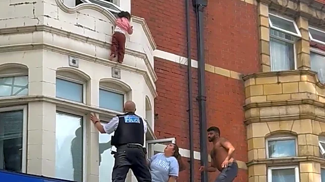 Child dangling from window saved in dramatic rescue