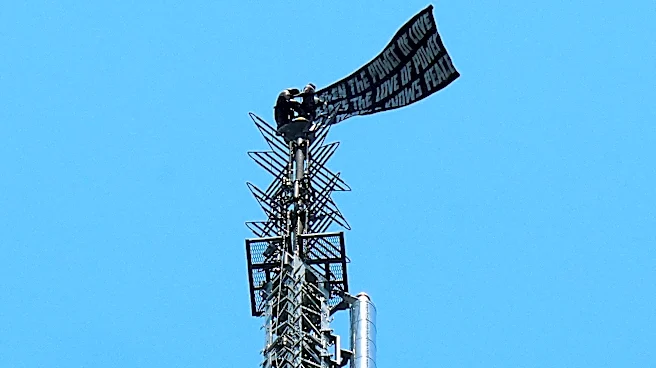 Two people scale Empire State Building and fly banner