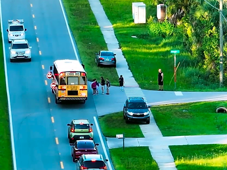 When can you legally pass and stopped school bus?