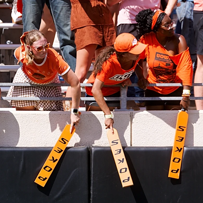 Oklahoma State storms field after stunning Oregon for Eric Morris' first win