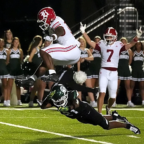 Tennessee commit David Gabriel Georges appears to levitate as he hurdles defender