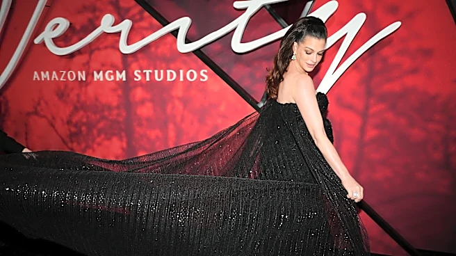 Anne Hathaway shows off baby bump in a glittering mermaid gown