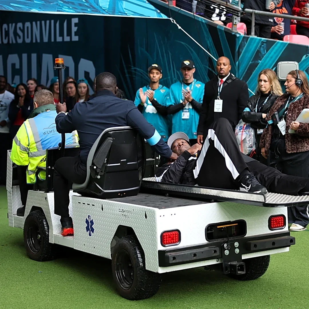 Official carted off with leg injury after falling on slippery London field