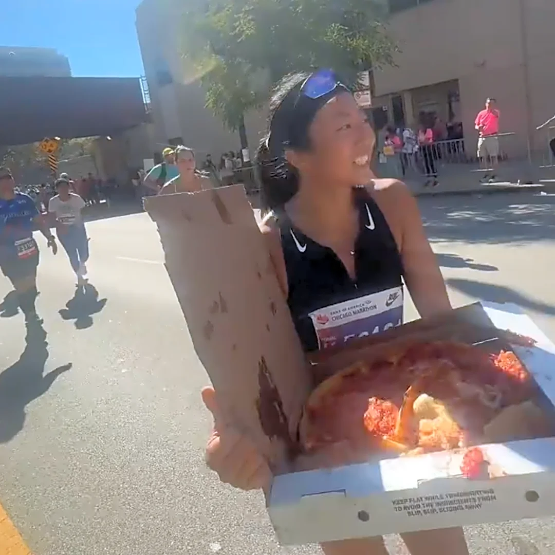 This marathoner does shots and eats pizza. Yes. During the race