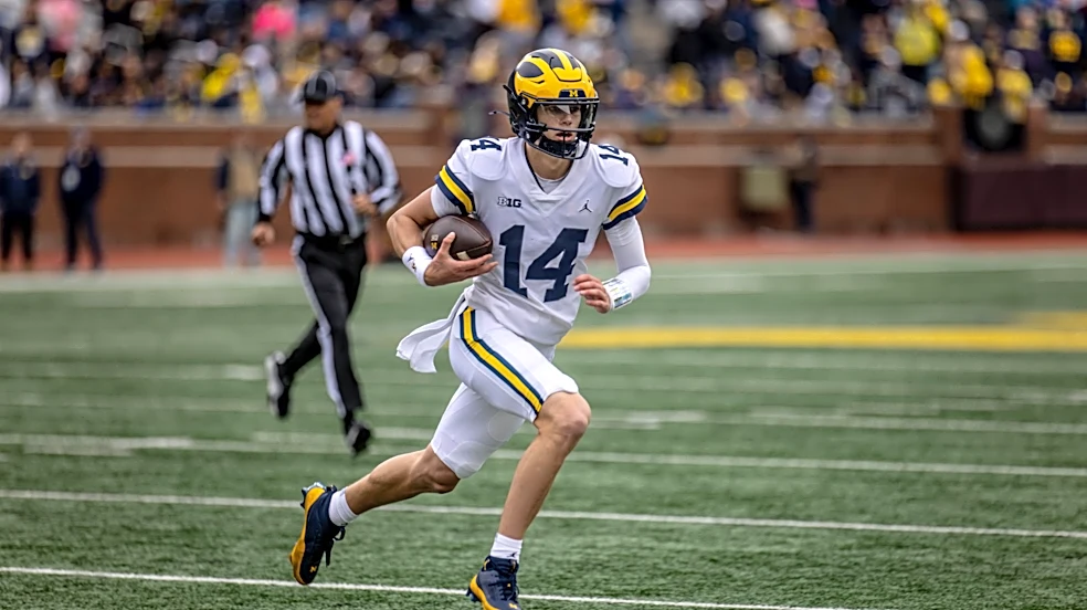 Michigan coach keeps starting quarterback plan quiet
